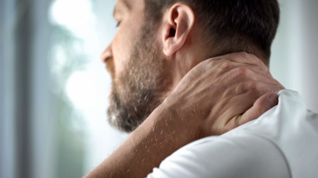 Middle-aged man feeling neck pain in morning, uncomfortable mattress, healthcare