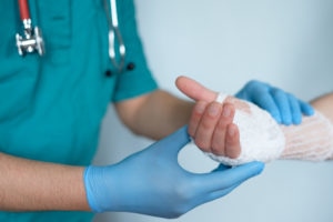 Doctor curando la mano de un paciente