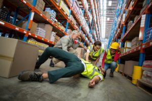 Worker fallen down while carrying boxes.