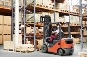 worker driving a warehouse forklift